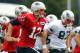 July 27, 2012; Foxborough, MA, USA; New England Patriots quarterback Tom Brady (12) and tight end Rob Gronkowski (87) run during training camp at the team practice facility. Mandatory Credit: Stew Milne-US PRESSWIRE