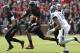 CINCINNATI, OH - DECEMBER 03: Munchie Legaux #4 of the Cincinnati Bearcats runs from Byron Jones #16 of the Connecticut Huskies on December 3, 2011 at Nippert Stadium in Cincinnati, Ohio. The Bearcats defeated the Connecticut Huskies 35-27. (Photo by Tyler Barrick/Getty Images)