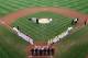 SOUTH WILLIAMSPORT, PA - AUGUST 28: Members of the Japan team from Hamamatsu City, Japan (L) and the West team from Huntington Beach, California line up before the start of the Little League World Series championship game on August 28, 2011 in South Williamsport, Pennsylvania. The West team defeated the team from Japan 2-1. (Photo by Rob Carr/Getty Images)