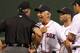BOSTON, MA - AUGUST 7: Bobby Valentine #25 of the Boston Red Sox has words with first base umpire Paul Nauet after Nauet ejected Dustin Pedroia #15 in the 9th inning against the Texas Rangers at Fenway Park August 7, 2012 in Boston, Massachusetts. Adrian Gonzalez #28 of the Boston Red Sox is looking on. (Photo by Jim Rogash/Getty Images)