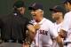 BOSTON, MA - AUGUST 7: Bobby Valentine #25 of the Boston Red Sox has words with first base umpire Paul Nauet after Nauet ejected Dustin Pedroia #15 in the 9th inning against the Texas Rangers at Fenway Park August 7, 2012 in Boston, Massachusetts. Adrian Gonzalez #28 of the Boston Red Sox is looking on. (Photo by Jim Rogash/Getty Images)