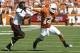 AUSTIN, TX - NOVEMBER 5: Quarterback David Ash #14 of the Texas Longhorns stiff arms cornerback Derrick Mays #4 of the Texas Tech Red Raiders in the second quarter on November 5, 2011 at Darrell K. Royal-Texas Memorial Stadium in Austin, Texas. (Photo by Erich Schlegel/Getty Images)