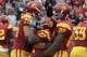 LOS ANGELES, CA - NOVEMBER 12: Running back Curtis McNeal #22 of the USC Trojans is sandwiched between tackle Matt Kalil #75 and tight end Randall Telfer #82 as they celebrate McNeal's 79 yard touchdown run in the third quarter against the Washington Huskies at the Los Angeles Memorial Coliseum on November 12, 2011 in Los Angeles, California. USC won 40-17. (Photo by Stephen Dunn/Getty Images)