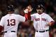 BOSTON, MA - MAY 22: Adrian Gonzalez #28 of the Boston Red Sox is congratulated by teammate Carl Crawford #13 after Gonzalez scored in the fourth inning against the Chicago Cubs on May 22, 2011 at Fenway Park in Boston, Massachusetts. Before this series, the two teams haven't played at Fenway Park since the 1918 World Series. (Photo by Elsa/Getty Images)
