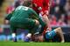 LIVERPOOL, ENGLAND - MARCH 03: Thomas Vermaelen of Arsenal lies injured on the pitch during the Barclays Premier League match between Liverpool and Arsenal at Anfield on March 3, 2012 in Liverpool, England. (Photo by Clive Mason/Getty Images)