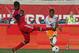 BRIDGEVIEW, IL - SEPTEMBER 02: Corey Ashe #26 of the Houston Dynamo fires a shot around Patrick Nyarko #14 of the Chicago Fire during an MLS match at Toyota Park on September 2, 2012 in Bridgeview, Illinois. (Photo by Jonathan Daniel/Getty Images)