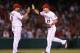 ANAHEIM, CA - SEPTEMBER 08: Mike Trout (R) #27 of the Los Angeles Angels of Anaheim is congratulated by Kendrys Morales #8 after making a leaping catch at the wall to record the final out of the game in the ninth inning against the Detroit Tigers at Angel Stadium of Anaheim on September 8, 2012 in Anaheim, California. The Angels defeated the Tigers 6-1. (Photo by Jeff Gross/Getty Images)