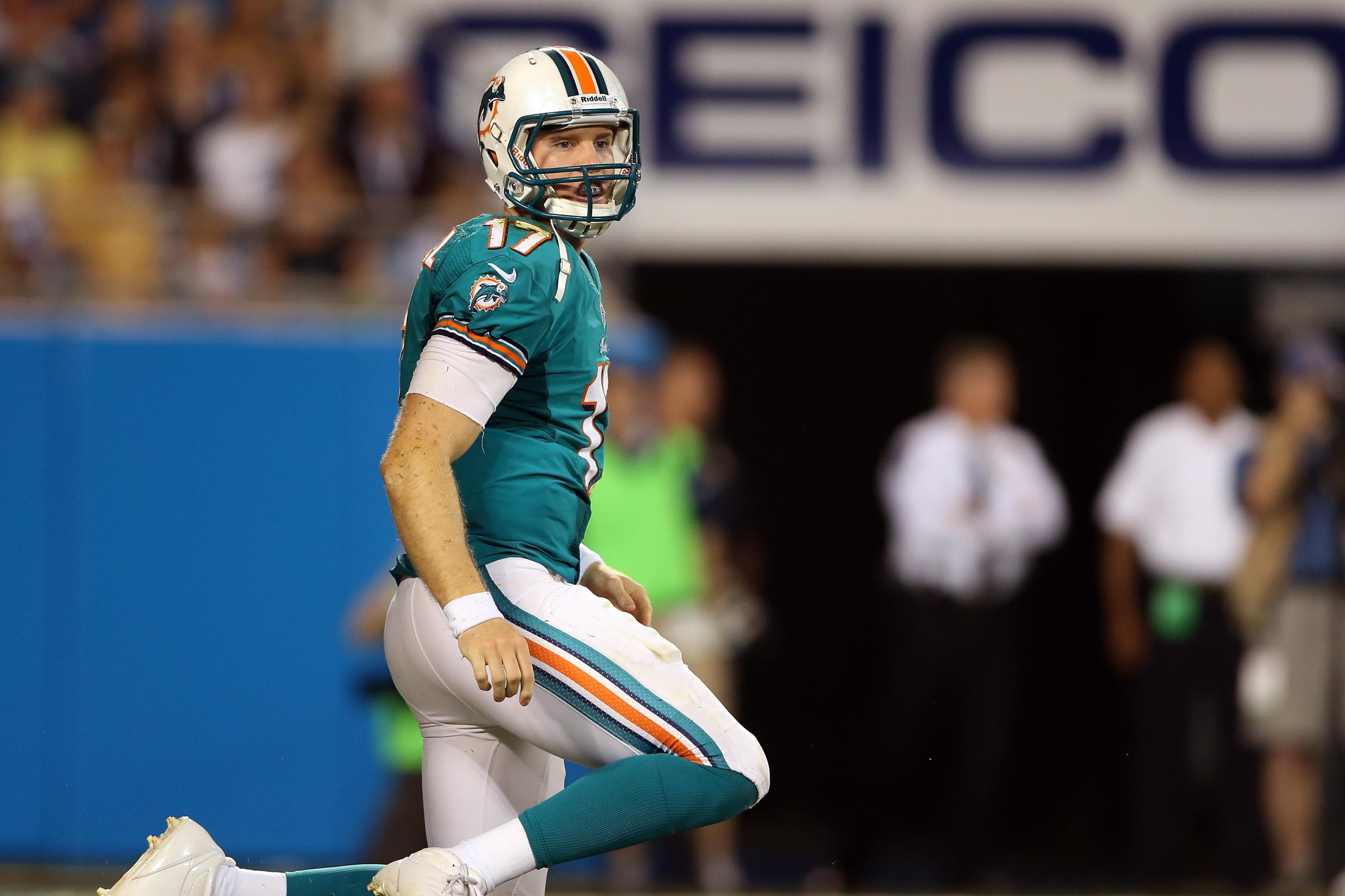 FILE - In this Oct. 14, 2018, file photo, injured Miami Dolphins  quarterback Ryan Tannehill cheers his team during the second half of an NFL  football game against the Chicago Bears, in