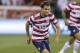 September 11, 2012; Columbus, OH, USA; USA midfielder Graham Zusi (19) carries the ball upfield under pursuit from Jamaica defender Je-Vaughn Watson (15) during a World Cup qualifying match at Columbus Crew Stadium. Mandatory Credit: Greg Bartram-US PRESSWIRE