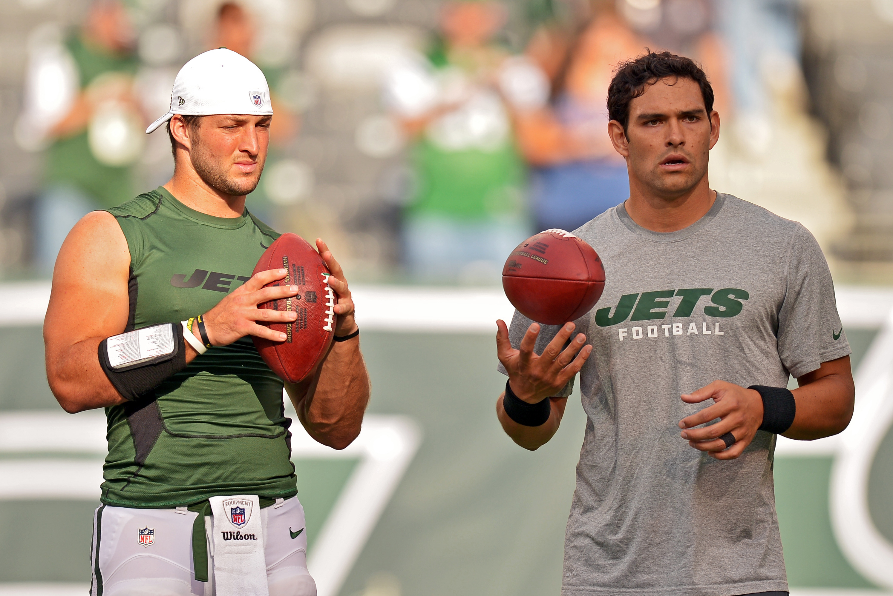 New York Jets Tim Tebow and Mark Sanchez warm up on the field before the  game against the New York Giants in a Pre Season NFL game at MetLife  Stadium in East