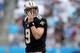 CHARLOTTE, NC - SEPTEMBER 16: Drew Brees #9 of the New Orleans Saints checks the scoreboard after a hit against the Carolina Panthers during their game at Bank of America Stadium on September 16, 2012 in Charlotte, North Carolina. (Photo by Streeter Lecka/Getty Images)