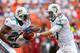 MIAMI GARDENS, FL - SEPTEMBER 16: Ryan Tannehill #17 of the Miami Dolphins hands off to Reggie Bush #22 during a game against the Oakland Raiders at Sun Life Stadium on September 16, 2012 in Miami Gardens, Florida. (Photo by Mike Ehrmann/Getty Images)