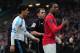 MANCHESTER, ENGLAND - FEBRUARY 11: Patrice Evra of Manchester United celebrates victory as he walks off with Luis Suarez of Liverpool during the Barclays Premier League match between Manchester United and Liverpool at Old Trafford on February 11, 2012 in Manchester, England. (Photo by Shaun Botterill/Getty Images)