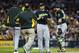 Brett Anderson (center, right) is visited by an athletic trainer and Bob Melvin on Sept. 19