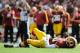 LANDOVER, MD - SEPTEMBER 23: Robert Griffin III #10 of the Washington Redskins lays on the ground after being hit by Manny Lawson #99 of the Cincinnati Bengals in the second half at FedExField on September 23, 2012 in Landover, Maryland. (Photo by Patrick McDermott/Getty Images)