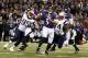 September 23, 2012; Baltimore, MD, USA; Baltimore Ravens quarterback Joe Flacco (5) evades New England Patriots defensive end Chandler Jones (95) and tackle Kyle Love (74) before throwing a touchdown pass to Torrey Smith (not shown) during the game at M&T Bank Stadium. Mandatory Credit: Mitch Stringer-US PRESSWIRE