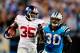 CHARLOTTE, NC - SEPTEMBER 20: Andre Brown #35 of the New York Giants breaks away from Charles Godfrey #30 of the Carolina Panthers for a long gain during play at Bank of America Stadium on September 20, 2012 in Charlotte, North Carolina. (Photo by Grant Halverson/Getty Images)