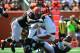 Sep 16, 2012; Cincinnati, OH, USA; Cincinnati Bengals quarterback Andy Dalton (14) is sacked by Cleveland Browns defensive end Juqua Parker (95) in the first quarter at Paul Brown Stadium. Mandatory Credit: Andrew Weber-US Presswire