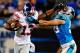 CHARLOTTE, NC - SEPTEMBER 20: Ramses Barden #13 of the New York Giants stiff-arms Luke Kuechly #59 of the Carolina Panthers during play at Bank of America Stadium on September 20, 2012 in Charlotte, North Carolina. (Photo by Grant Halverson/Getty Images)