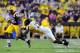 BATON ROUGE, LA - SEPTEMBER 29: Telvion Clark #13 of the Towson Tigers dives for MichaelFord #42 of the LSU Tigers during a game at Tiger Stadium on September 29, 2012 in Baton Rouge, Louisiana. (Photo by Stacy Revere/Getty Images)