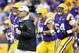 LSU head coach Les Miles leads his team out of the tunnel