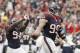 HOUSTON, TX- SEPTEMBER 30: J.J. Watt #99 of the Houston Texans and Antonio Smith #94 of the Houston Texans celebrate a fumble recovery against the Tennessee Titans defense on September 30, 2012 at Reliant Stadium in Houston, Texas. Houston Texans won 38 to 14. (Photo by Thomas B. Shea/Getty Images)