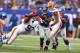 EAST RUTHERFORD, NJ - OCTOBER 07: Ahmad Bradshaw #44 of the New York Giants breaks the tackle of John Hughes #93 of the Cleveland Browns during their game at MetLife Stadium on October 7, 2012 in East Rutherford, New Jersey. (Photo by Al Bello/Getty Images)