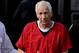 BELLEFONTE, PA - OCTOBER 09: Former Penn State assistant football coach Jerry Sandusky leaves the Centre County Courthouse after being sentenced in his child sex abuse case on October 9, 2012 in Bellefonte, Pennsylvania. The 68-year-old Sandusky was sentenced to at least 30 years and not more that 60 years in prison for his conviction in June on 45 counts of child sexual abuse, including while he was the defensive coordinator for the Penn State college football team. (Photo by Patrick Smith/Getty Images)