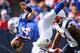 ORCHARD PARK, NY - SEPTEMBER 30: Ryan Fitzpatrick #14 of the Buffalo Bills is tackled by Tavon Wilson #27 of the New England Patriots at Ralph Wilson Stadium on September 30, 2012 in Orchard Park, New York.New England won 52-28. (Photo by Rick Stewart/Getty Images)