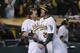 OAKLAND, CA - OCTOBER 10: Josh Reddick #16 and Josh Donaldson #20 of the Oakland Athletics celebrates after they scored on a Seth Smith double to tie their game against the Detroit Tigers in the ninth inning during Game Four of the American League Division Series at Oakland-Alameda County Coliseum on October 9, 2012 in Oakland, California. (Photo by Thearon W. Henderson/Getty Images)