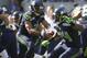 SEATTLE, WA - SEPTEMBER 16: Quarterback Russell Wilson #3 of the Seattle Seahawks drops back to pass during a game against the Dallas Cowboys at CenturyLink Field on September 16, 2012 in Seattle, Washington. At right is Marshawn Lynch #24. (Photo by Stephen Brashear/Getty Images)