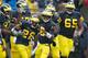 ANN ARBOR, MI - OCTOBER 13: Fitzgerald Toussaint #28 of the Michigan Wolverines celebrates a third quarter touchdown with Denard Robinson #16 and the rest of his offensive teammates while playing the Illinois Fighting Illini at Michigan Stadium on October 13, 2012 in Ann Arbor, Michigan. Michigan won the game 45-0. (Photo by Gregory Shamus/Getty Images)