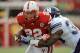 LINCOLN, NE - NOVEMBER 5: Running back Rex Burkhead #22 of the Nebraska Cornhuskers drives through a tackle by linebacker David Nwabuisi #33 of the Northwestern Wildcats during their game at Memorial Stadium November 5, 2011 in Lincoln, Nebraska. (Photo by Eric Francis/Getty Images)