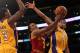 LOS ANGELES, CA - JANUARY 13: Ramon Sessions #3 of the Cleveland Cavaliers goes up for a shot between Darius Morris #1 and Devin Ebanks #3 of the Los Angeles Lakers at Staples Center on January 13, 2012 in Los Angeles, California. The Lakers won 97-92. NOTE TO USER: User expressly acknowledges and agrees that, by downloading and or using this photograph, User is consenting to the terms and conditions of the Getty Images License Agreement. (Photo by Stephen Dunn/Getty Images)