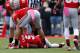 COLUMBUS, OH - OCTOBER 20: Devin Smith #15 and Jake Stoneburner #11, check on Braxton Miller #5, all of the Ohio State Buckeyes, after Miller was injured while running the ball during the fourth quarter against the Purdue Boilermakers on October 20, 2012 at Ohio Stadium in Columbus, Ohio. Miller did not return to the game.(Photo by Kirk Irwin/Getty Images)