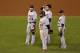 Detroit players stand on the field in the team's Game 2 loss of the World Series to the San Francisco Giants