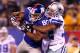 EAST RUTHERFORD, NJ - JANUARY 01: Victor Cruz #80 of the New York Giants goes up to make a catch against Orlando Scandrick #32 of the Dallas Cowboys in the fourth quarter at MetLife Stadium on January 1, 2012 in East Rutherford, New Jersey. (Photo by Al Bello/Getty Images)