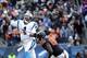 Cam Newton (1) throws on the run with a Chicago defender on his heels.