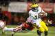 LINCOLN, NE - OCTOBER 27: Quarterback Denard Robinson #16 of the Michigan Wolverines slips past defensive end Jason Ankrah #9 of the Nebraska Cornhuskers during the first half of their game at Memorial Stadium on October 27, 2012 in Lincoln, Nebraska. Nebraska won 23-9. (Photo by Eric Francis/Getty Images)