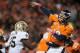 DENVER, CO - OCTOBER 28: Quarterback Peyton Manning #18 of the Denver Broncos releases a pass just before slightly injuring his hand by hitting the helmet of defensive end Martez Wilson #95 of the New Orleans Saints during a game at Sports Authority Field Field at Mile High on October 28, 2012 in Denver, Colorado. The Broncos defeated the Saints 34-14. (Photo by Dustin Bradford/Getty Images)