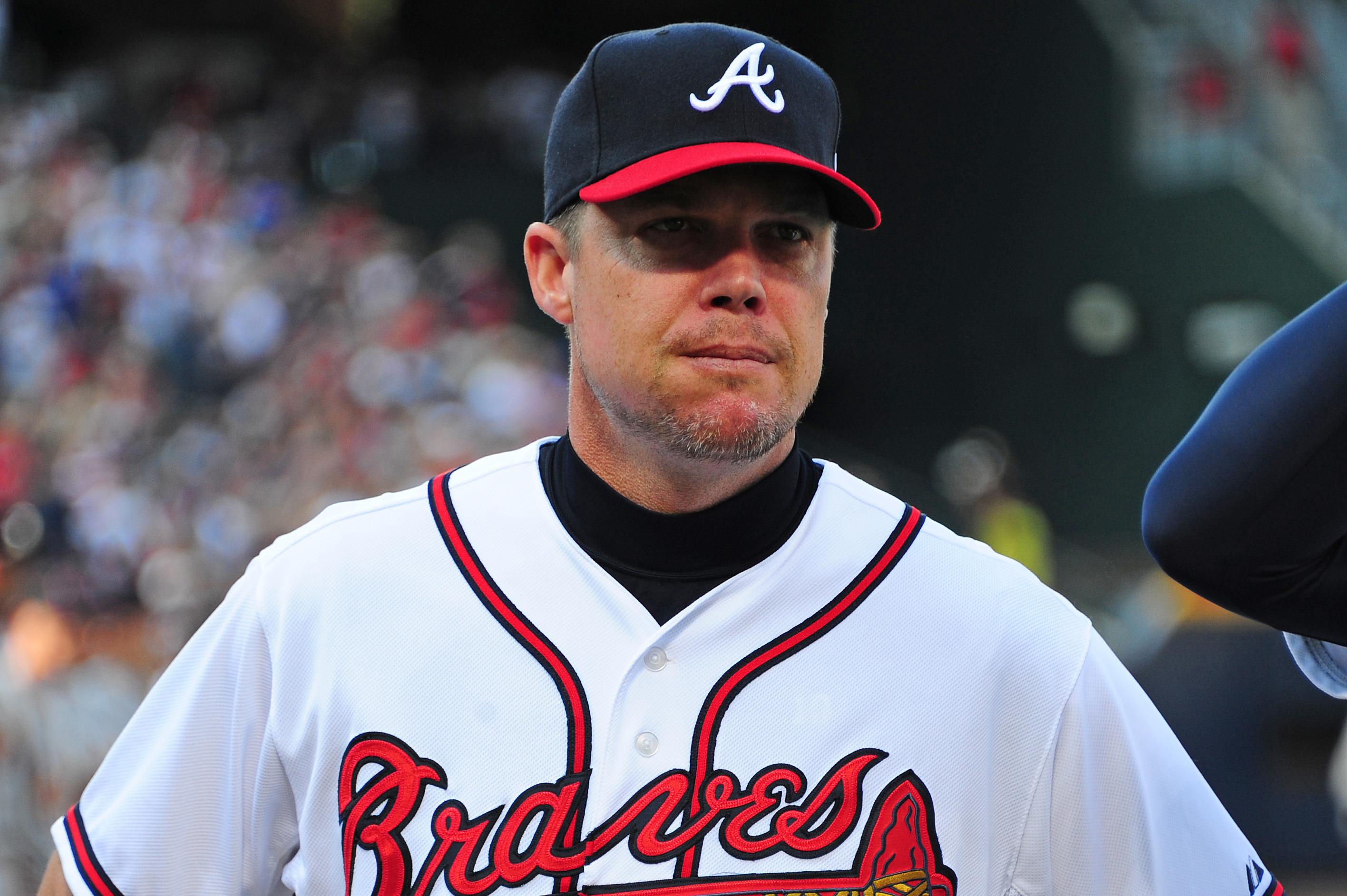 Former Atlanta Braves outfielder Andruw Jones, right, sits with