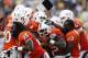 ATLANTA, GA - SEPTEMBER 22: Mike James #5 of the Miami Hurricanes gets mobbed by teammates after rushing for a 25-yard touchdown in overtime to win the game against the Georgia Tech Yellow Jackets at Bobby Dodd Stadium on September 22, 2012 in Atlanta, Georgia. Miami won 42-36. (Photo by Joe Robbins/Getty Images)