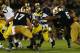 SOUTH BEND, IN - SEPTEMBER 22: Running back Fitzgerald Toussaint #28 of the Michigan Wolverines has his face mask grabbed by linebacker Manti Te'o #5 of the Notre Dame Fighting Irish in the third quarter at Notre Dame Stadium on September 22, 2012 in South Bend, Indiana. (Photo by Jonathan Daniel/Getty Images)