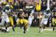 Drew Dileo runs from Spartans during Michigan's 12-10 win over the Spartans