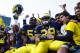 November 10, 2012; Ann Arbor, MI, USA; Michigan Wolverines linebacker Royce Jenkins-Stone (52) and running back Thomas Rawls (38) celebrate with fans after the game against the Northwestern Wildcats at Michigan Stadium. Michigan won in overtime 38-31. Mandatory Credit: Rick Osentoski-US PRESSWIRE
