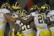 CHAMPAIGN, IL - NOVEMBER 12: Fitzgerald Toussaint #28 of the Michigan Wolverines is congratulated after scoring a touchdown by (L-R) Mark Huyge #72, Devin Gardner #7, Junior Hemingway #21 and Brandon Moore #89 against the Illinois Fighting Illini at Memorial Stadium on November 12, 2011 in Champaign, Illinois. Michigan defeated Illinois 31-14. (Photo by Jonathan Daniel/Getty Images)