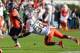 CHARLOTTESVILLE, VA - NOVEMBER 10: Running back Perry Jones #33 of the Virginia Cavaliers carries the ball as defensive back A.J. Highsmith #30 of the Miami Hurricanes attempts to make the tackle at Scott Stadium on November 10, 2012 in Charlottesville, Virginia. (Photo by Geoff Burke/Getty Images)