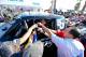 November 14, 2012; Ensenada, BC, Mexico; SCORE trophy truck driver Zak Langley hands out hats to the crowd during technical inspection and contingency for the SCORE Tecate Baja 1000. Mandatory Credit: Matt Kartozian-US PRESSWIRE