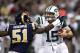ST. LOUIS, MO - NOVEMBER 18: Quarterback Tim Tebow #15 of the New York Jets stiff arms linebacker Mario Haggan #51 of the St. Louis Rams during the game at the Edward Jones Dome on November 18, 2012 in St. Louis, Missouri. (Photo by David Welker/Getty Images)