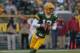 GREEN BAY, WI - NOVEMBER 04: Aaron Rodgers #12 of the Green Bay Packers rolls out to look for a receiver against the Arizona Cardinals at Lambeau Field on November 4, 2012 in Green Bay, Wisconsin. The Packers defeated the Cardinals 31-17. (Photo by Jonathan Daniel/Getty Images)